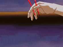 a hand with long nails is holding two red sticks