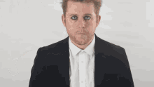 a man in front of a white board that says hey ll feed