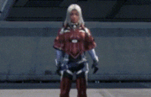 a woman in a red suit is standing in front of a building in a video game .