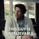 a man sitting on a couch with the words this guy is unbelievable
