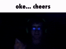 a person is holding a box of cigarettes in their hand in the dark .