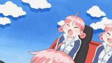 a girl with pink hair is sitting on a roller coaster with other girls