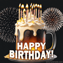 a birthday cake made out of a beer mug with candles and fireworks behind it