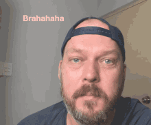 a man with a beard wearing a hat with the word brahaha written on it