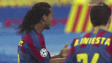 two soccer players are giving each other a thumbs up in front of a sky sport hd sign
