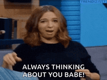 a woman is sitting on a couch and saying always thinking about you babe !