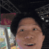 a close up of a man 's face with a sign in the background that says ' e ' on it