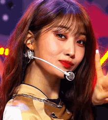a close up of a woman wearing a microphone and earrings