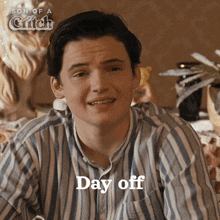 a young man in a striped shirt is smiling with the words day off below him