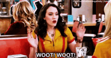 a woman in a yellow shirt says wooti wooti in a diner