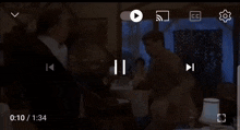 two men are hugging in a restaurant with a lamp on the table