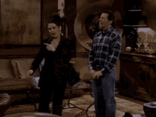 a man and a woman are dancing together in a living room