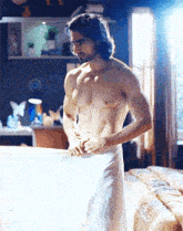 a shirtless man with a towel around his waist