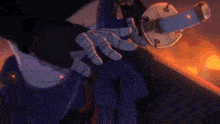 a person is holding a sword in their hand in a dark room .