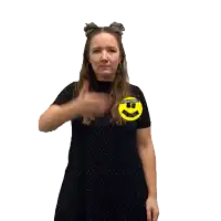 a woman in a black dress covering her eyes with a sticker on her shirt that says dressing