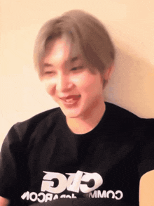 a young man wearing a black t-shirt that says cic