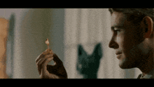 a man is holding a lit match in his hand and looking at it