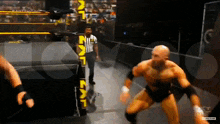 a man in a wrestling ring with a referee and a sign that says nxt