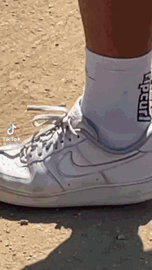 a person wearing a pair of rip curl socks and a pair of white nike shoes
