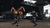 a man in a robot costume is fighting another man in a warehouse