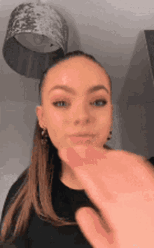 a woman is being touched by a man 's hand .