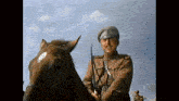 a man in a military uniform is riding a horse .