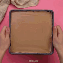 a person is sifting cocoa powder on a piece of cake on a cutting board .