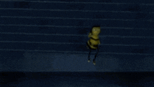 a cartoon bee is standing in front of a building and looking up at the sky .