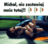 a man laying on the ground with the words michat nie zostawiaj mnie tutaj written above him