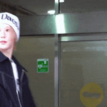 a person wearing a white beanie with the word peace on it
