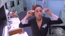 a woman brushing her teeth in front of a mirror