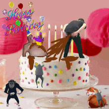 a birthday cake with a monkey and a hamster on it