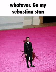 a man in a tuxedo is standing on a pink carpet with the words " whatever go my sebastian stan "