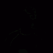 a man is laughing with his mouth open and his eyes closed while wearing a black jacket .