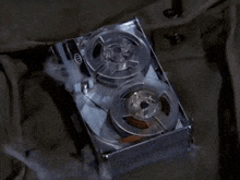 a close up of a tape recorder with two reels of tape on it .