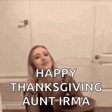 a woman says happy thanksgiving aunt irma in front of a wall