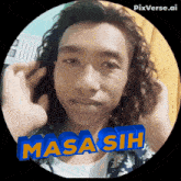 a man with long curly hair has masa sih written on his head
