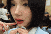 a close up of a person applying lipstick to another person 's lips