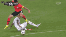 a soccer player with the number 5 on his jersey is dribbling the ball