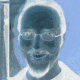 a man with glasses and a beard has a blue background