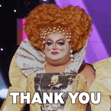 a drag queen is wearing a newspaper dress with a picture of shakespeare on it and says thank you