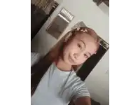 a young girl taking a selfie with a mirror in the background