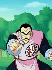 a man in a pink shirt with chinese writing on it points at the camera