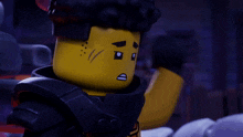 a close up of a lego character 's face with a black hair