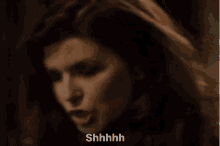 a close up of a woman saying shhhh