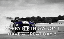 a black and white photo of a mustang drifting on a race track .