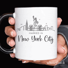 a white coffee mug that says married in new york city