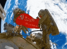 a man in a space suit holds a red flag that says 70 on it
