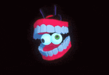 a cartoon mouth with blue teeth and a green eye on a black background