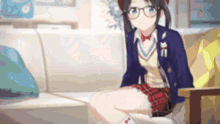 a girl in a school uniform is sitting on a couch .